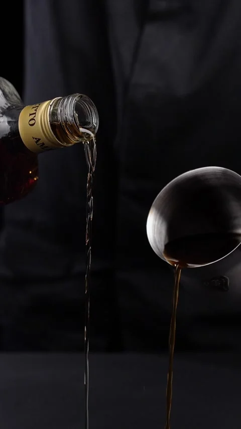 Bartender pouring coffee from a Turk and whiskey from a bottle into a cocktail Stock Footage 281668450
