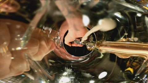 Bartender pouring craft beer into glass . Camera inside the beer glass or cup Stock Footage 163749147