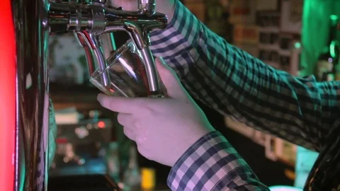 Bartender Pouring Craft Beer From Tap. Bartender pouring a perfect draft beer Stock Footage 84760530