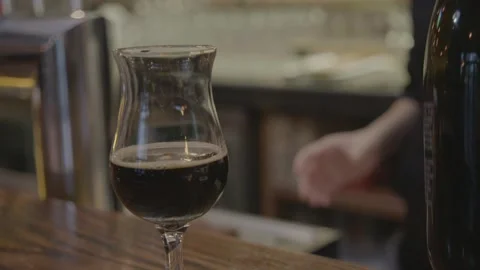 Bartender Pouring Dark Beverage Into Glass at Bar Counter in Beijing, China Stock Footage 345756677