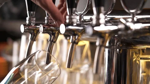 Bartender pouring draft beer in the bar. Close-up demonstration video. Beer is Stock Footage 106244894