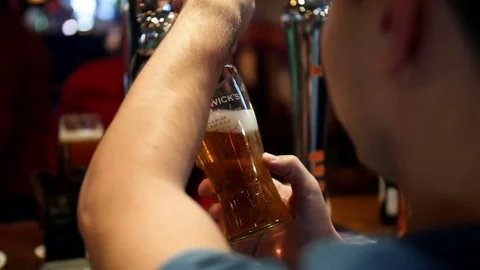 Bartender pouring draft beer. Night club Stock Footage 70947076