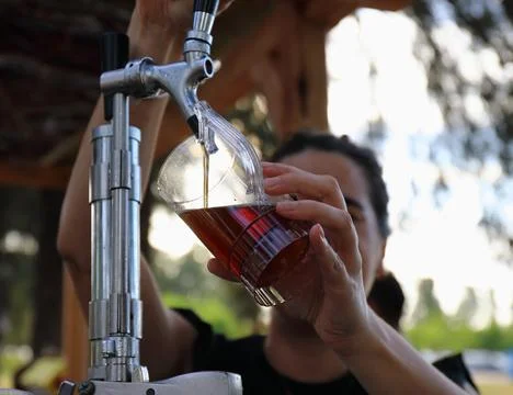 Bartender Pouring Draft Beer into Plastic Cup 写真素材
