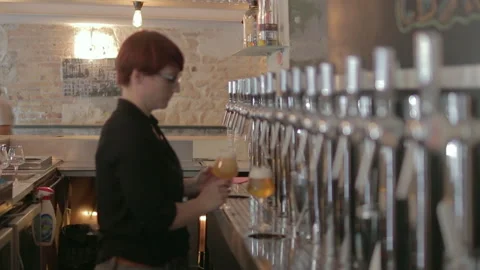 Bartender Pouring Draft Beer From Tap Row In Modern Bar Stock-Footage 344294996