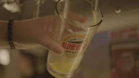 Bartender Pouring Draft Beverage Into Glass at Bar Counter in Beijing, China Stock Footage 345758215