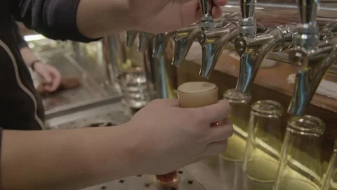 Bartender Pouring Draft Drinks from Taps at Bar Counter in Beijing, China Stock Footage 345751333