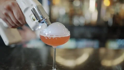 A bartender is pouring a drink into a glass Stock-Footage 295996330