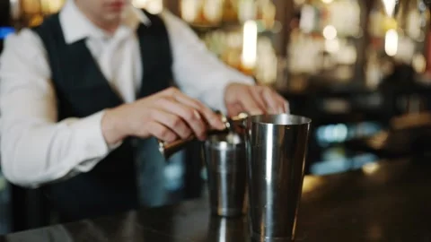 A bartender is pouring a drink into a shaker Video stock 295996371