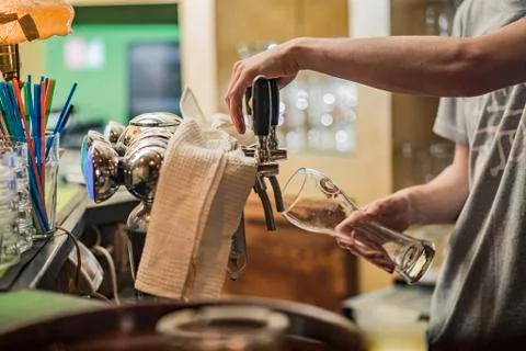 Bartender pouring fresh beer Stock Photos