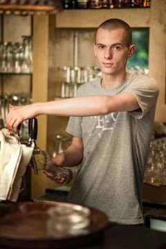 Bartender pouring fresh beer Stock Photos