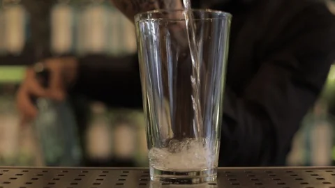 Bartender Pouring Gin with Jigger For a Cocktail Stock Footage 129780749