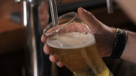 Bartender pouring glass of draft beer. Close up Stock Footage 63986150