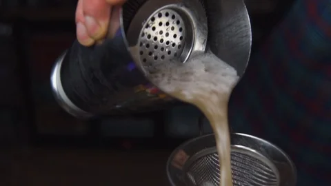 Bartender pouring juice into funnel Stock Footage 90122988