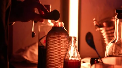 Bartender Pouring Measured Liquid into Bottle in Moody Bar Light Stock Footage 318001826