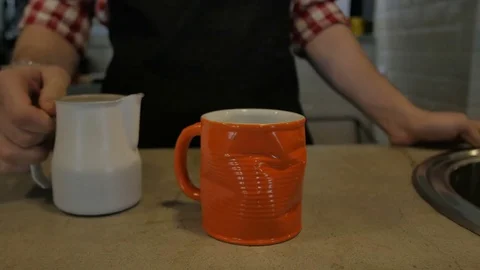 Bartender pouring milk to cup Видео 75876928