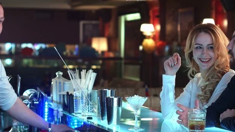 Bartender pouring mixed cocktail for clients in a bar Vídeos de archivo 76634959