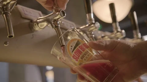 Bartender Pouring Red Draft Beverage from Tap into Glass at Bar in Beijing Stock Footage 345759040