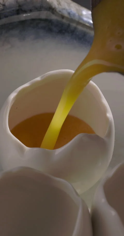 Bartender pouring refreshing cocktail from shaker in egg shots. Summer drink Stock Footage 312641271