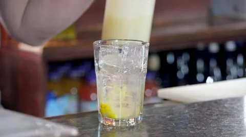 Bartender Pouring Sour Mix into Bar Glass for Cocktail Stock Footage 58173393