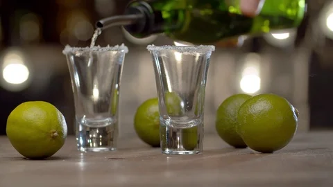 Bartender pouring tequila into the glasses Stock Footage 125389912
