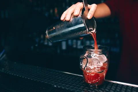 Bartender pouring using strainer White Sweet juicy  Cherry Cocktail drink in  Stock Photos