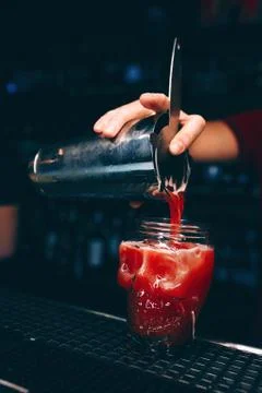 Bartender pouring using strainer White Sweet juicy  Cherry Cocktail drink in  Foto stock