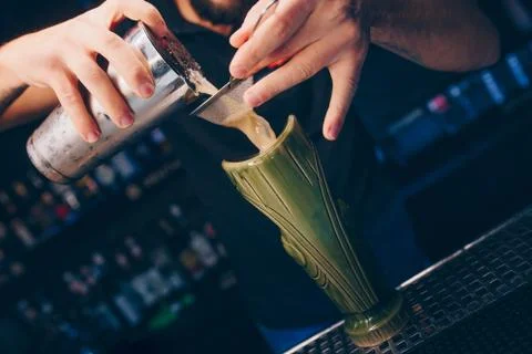 Bartender pouring using strainer White healthy Cocktail drink on a bar counte Stock Photos