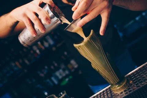 Bartender pouring using strainer White healthy Cocktail drink on a bar counte Stock Photos