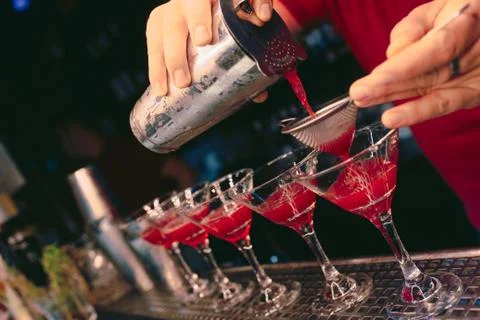 Bartender pouring using strainer White healthy Cocktail drink on a bar counte Stock Photos