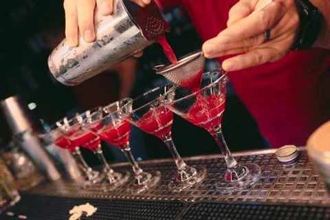 Bartender pouring using strainer White healthy Cocktail drink on a bar counte Stock Photos