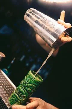 Bartender pouring using strainer White healthy Cocktail drink on a bar counte Stock Photos