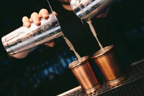 Bartender pouring using strainer White healthy Cocktail drink on a bar counte Stock Photos