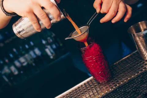 Bartender pouring using strainer White healthy Cocktail drink on a bar counte Stock Photos