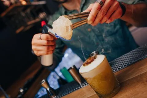Bartender pouring using strainer White healthy Cocktail drink on a bar counte Stock Photos