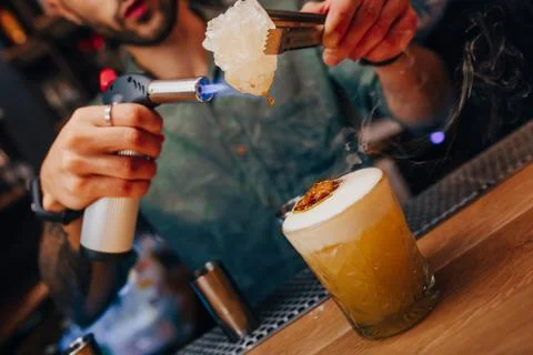 Bartender pouring using strainer White healthy Cocktail drink on a bar counte Stock Photos