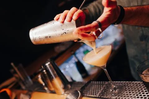 Bartender pouring using strainer White healthy Cocktail drink on a bar counte Stock Photos