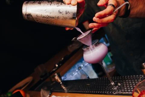 Bartender pouring using strainer White healthy Cocktail drink on a bar counte Stock Photos