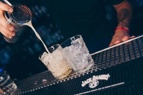 Bartender pouring using strainer White healthy Cocktail drink on a bar counte Stock Photos