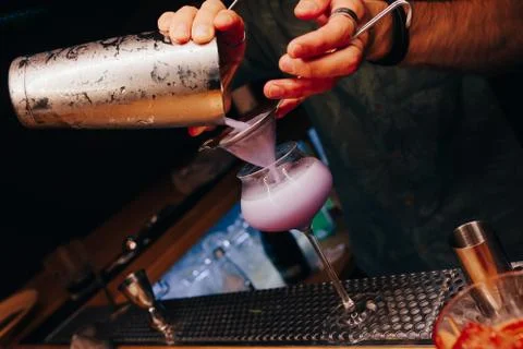 Bartender pouring using strainer White healthy Cocktail drink on a bar counte Stock Photos