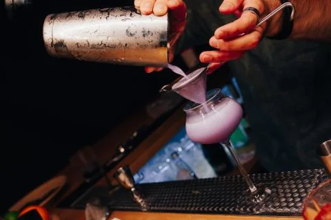 Bartender pouring using strainer White healthy Cocktail drink on a bar counte Stock Photos