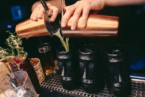 Bartender pouring using strainer White healthy Cocktail drink on a bar counte Stock Photos