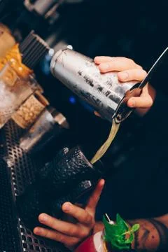 Bartender pouring using strainer White healthy Cocktail drink on a bar counte Stock Photos