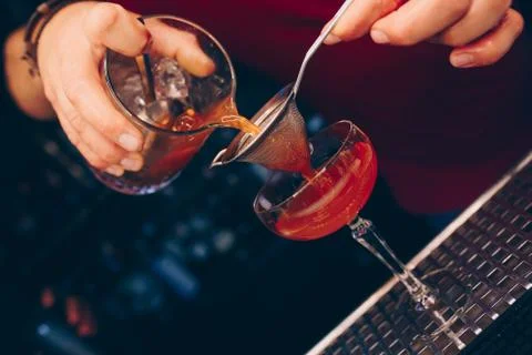 Bartender pouring using strainer White healthy Cocktail drink on a bar counte Stock Photos