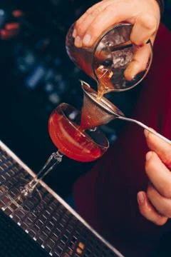 Bartender pouring using strainer White healthy Cocktail drink on a bar counte Stock Photos