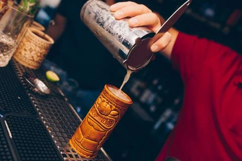 Bartender pouring using strainer White healthy Cocktail drink on a bar counte Stock Photos