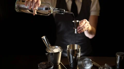 Bartender pouring vodka into cocktail measuring cup Stock Footage 124693330