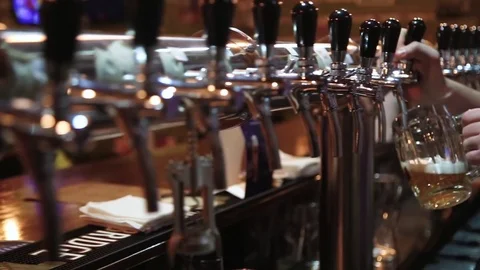Bartender pours the beer into the mug Video stock 75641923