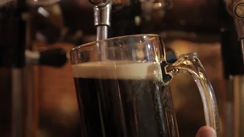 The bartender pours a beer in a mug Stock Footage