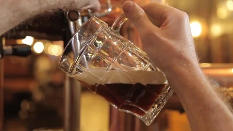 The bartender pours a beer in a mug Stock Footage 80637916