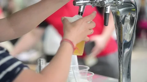 Bartender pours a beer in a plastic cup - Open Beer Festival Stock-Footage 64711154